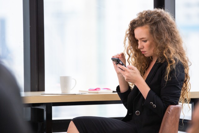 woman reading messages on phone 