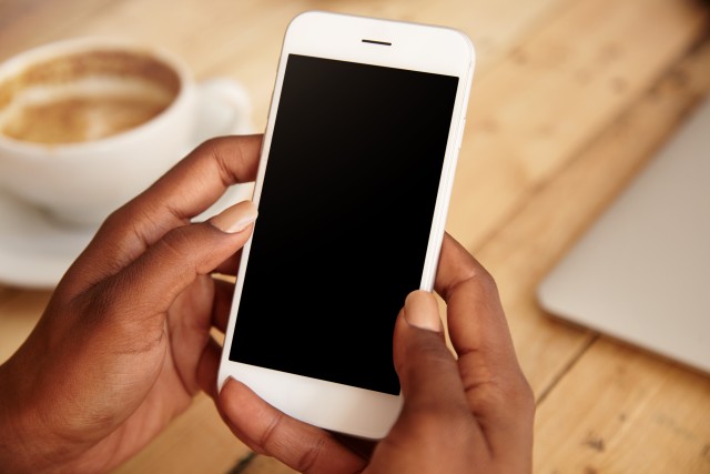 close up of woman holding a phone